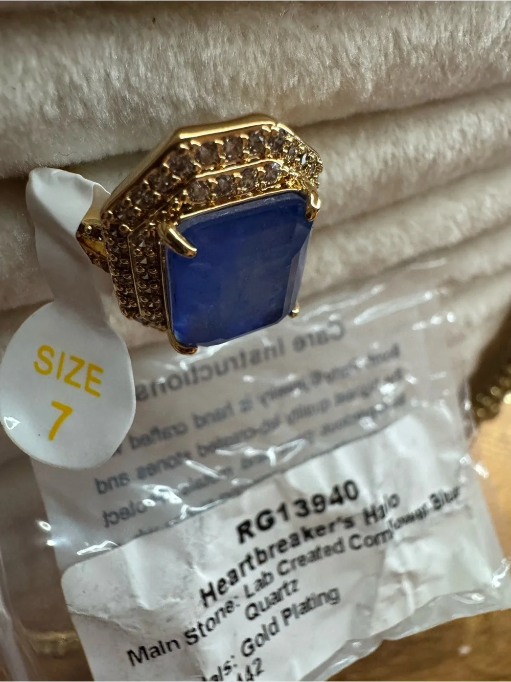 Heartbreaker’s Halo Gold Cocktail Ring with Deep Blue Center Stone